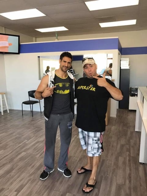 Two men posing with boxing gloves