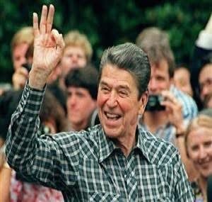 Man in checkered shirt waving to crowd