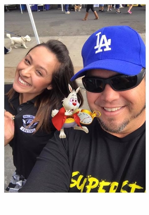 Man in LA Dodgers cap with young woman at baseball stadium