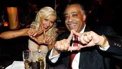 Two people smiling and making fist gestures