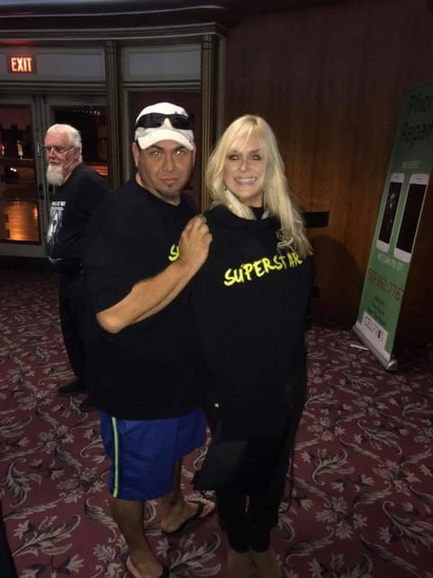 Two people posing together indoors wearing black Supernatural shirts