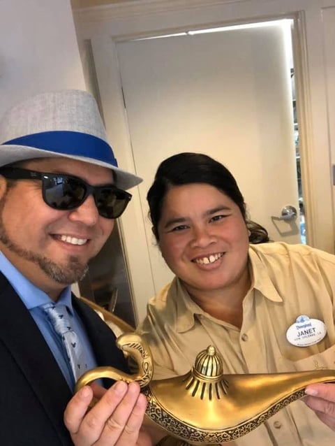 Two people posing with golden magic lamp