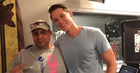 Two men smiling at camera